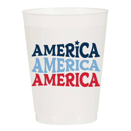 White cup with 'AMERICA' printed in blue, red, and light blue on a white background