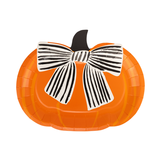 Pumpkin-shaped paper plate with a black and white bow on a white background