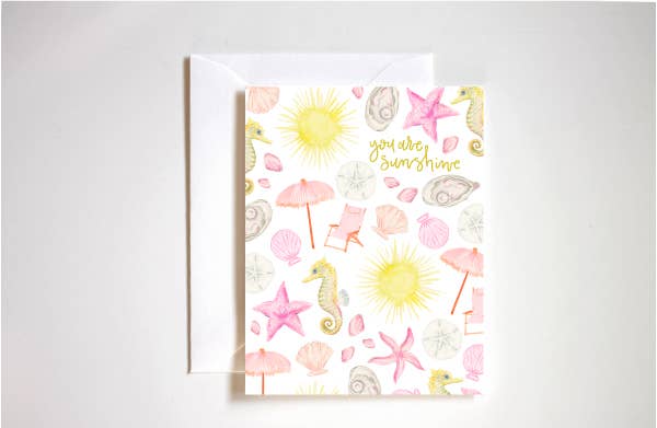 Greeting card with beach-themed illustrations with seashells, sun, and umbrellas