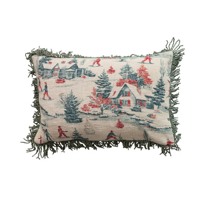 Vintage ski lodge lumbar pillow with a winter scene of skiers, snowy cottages, evergreen trees, and sage green fringe trim.