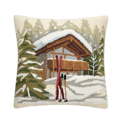 Decorative apres ski pillow with a winter scene of a alpine cabin and skiers.