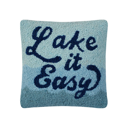 Blue pillow with 'Lake it Easy' text in hooked wool