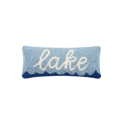 Decorative pillow with 'lake' text on a light blue background